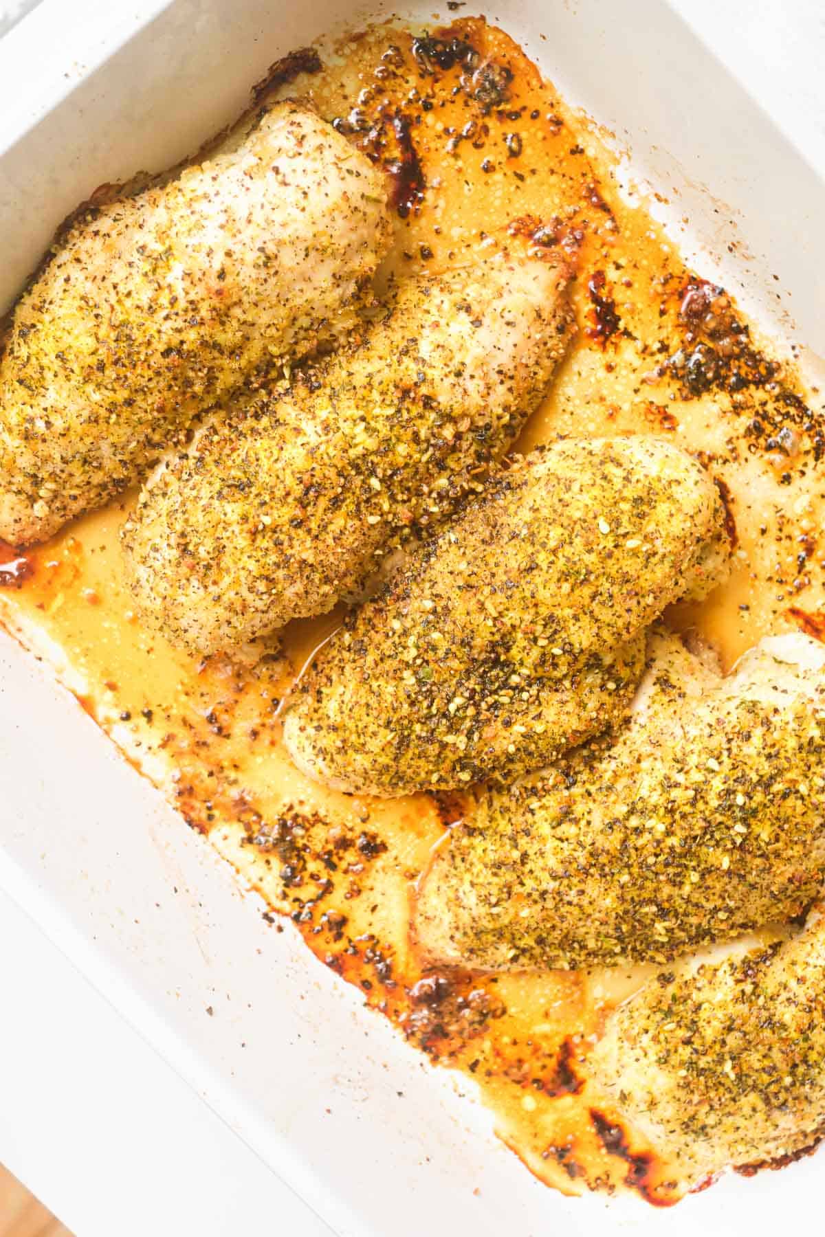 the completed lemon pepper chicken breast in a baking dish