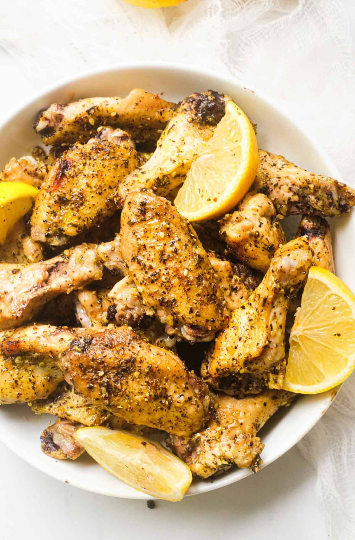 top down view of a bowl filled with the completed lemon pepper chicken wings