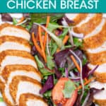SLICED BREADED CHICKEN BREAST ON A PLATE WITH SALAD