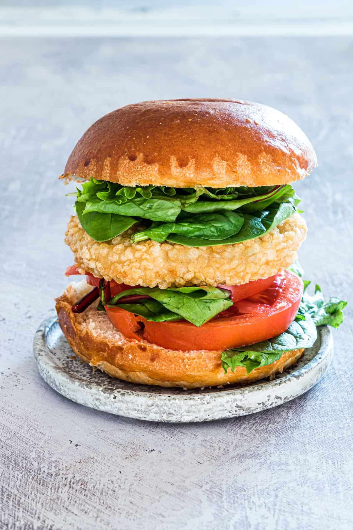 side view of one of the completed frozen chicken patties in air fryer served on a bun