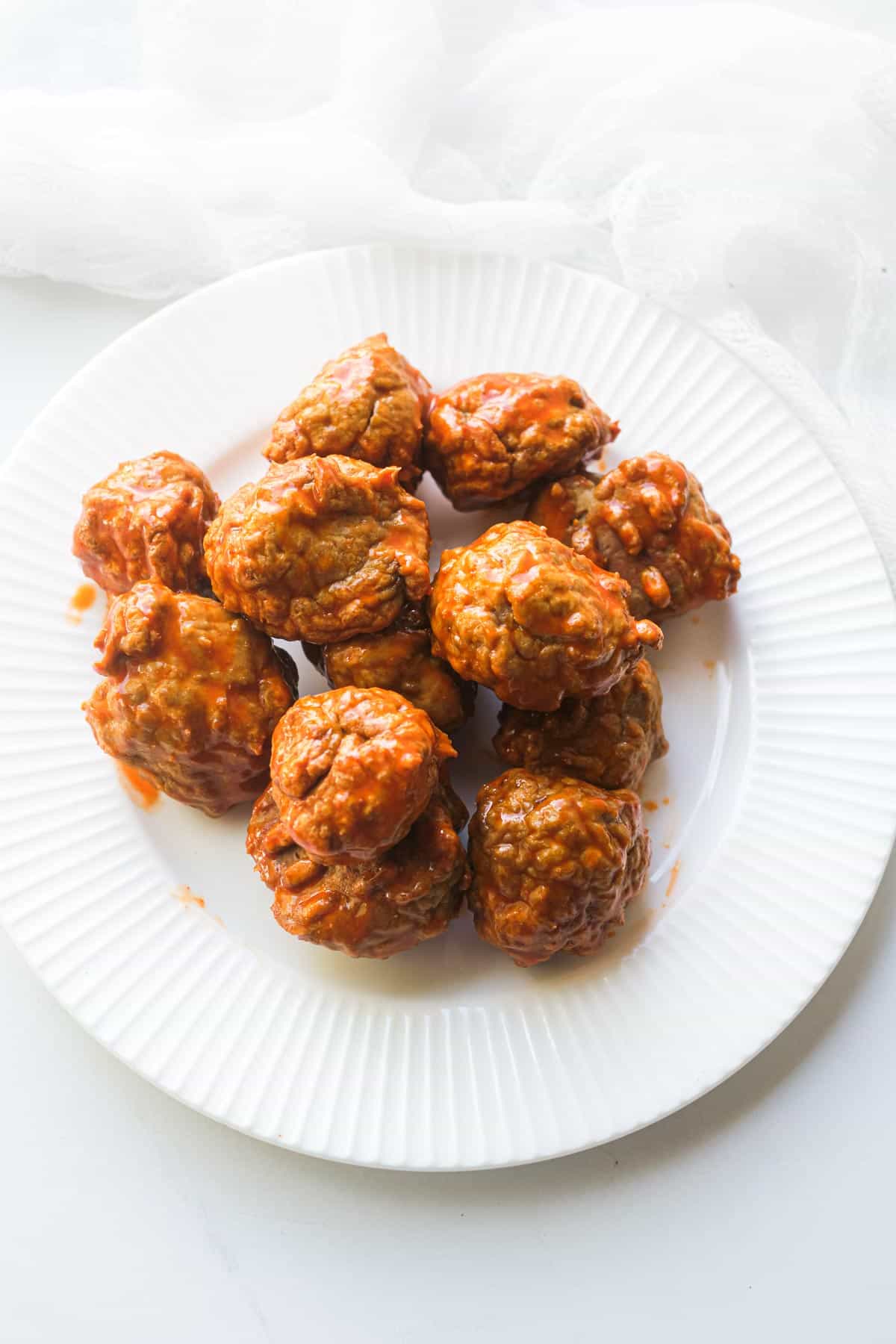 a plate of cooked buffalo chicken meatballs