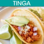 chicken tinga tacos on a plate with lime slices