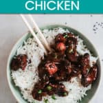 general tso's chicken over rice with chopsticks