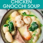 a bowl of chicken gnocchi soup with a wooden spoon