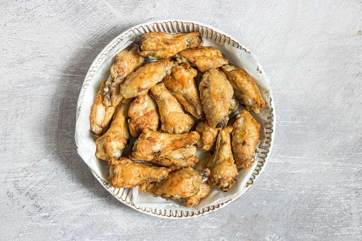a plate of cooked air fryer frozen chicken wings
