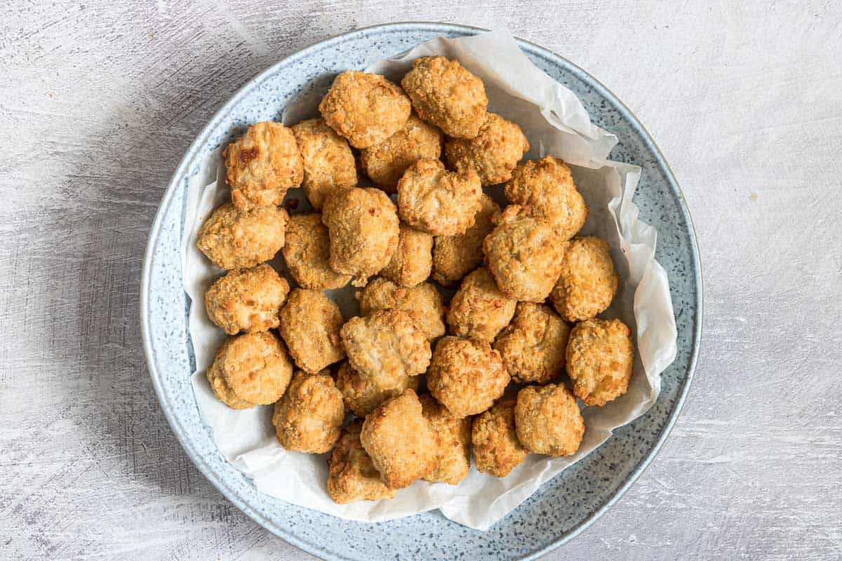 a bowl filled with chicken nuggets that have been reheated in air fryer