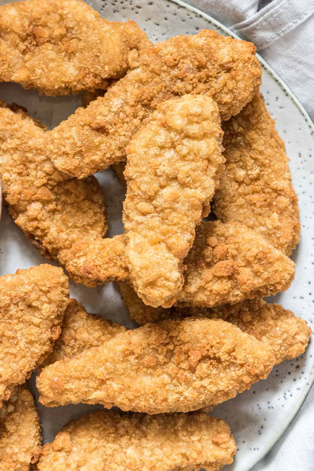 a portion of reheat breaded chicken tenders in air fryer served on a plate
