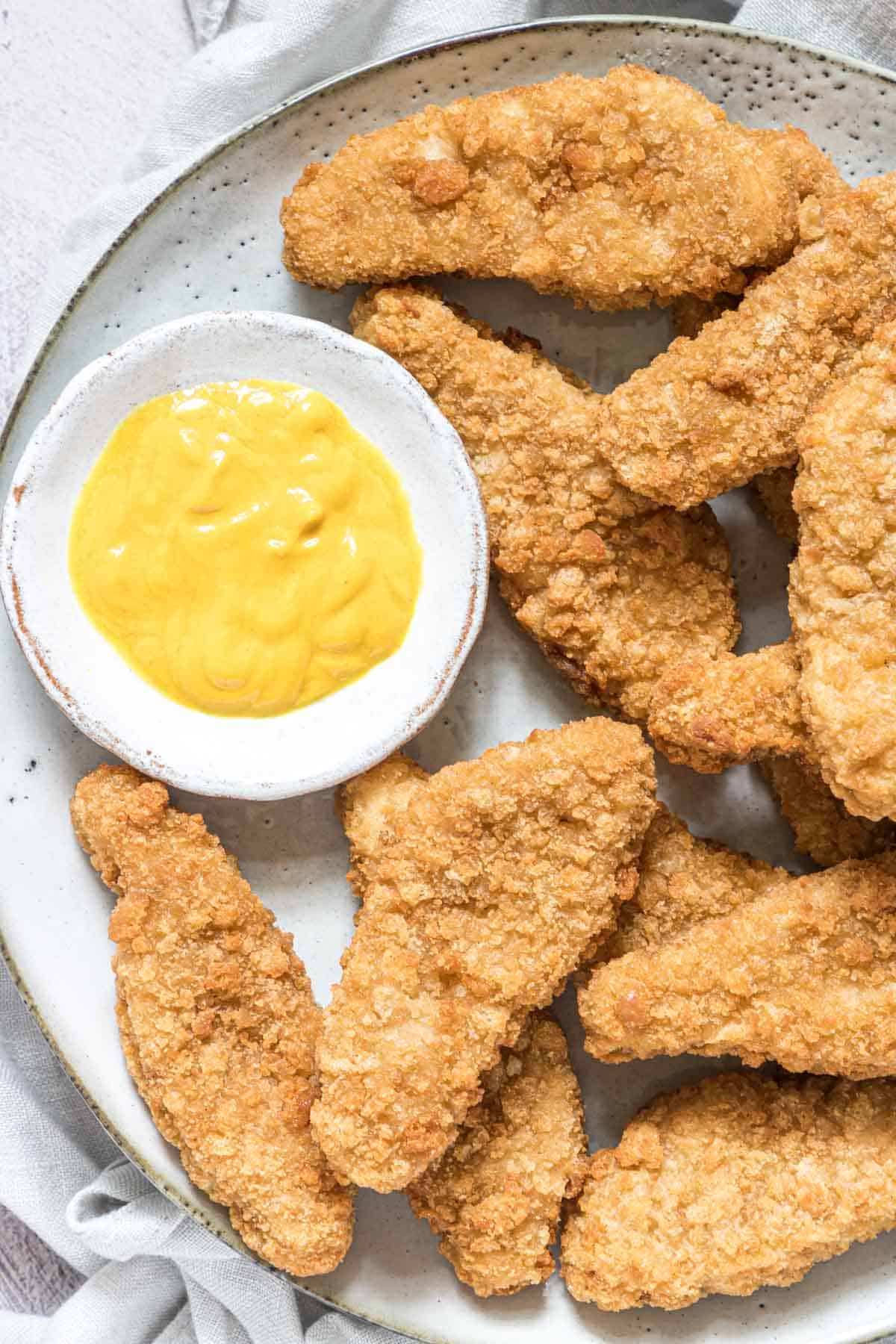 close up view of a serving of reheat chicken tenders in air fryer