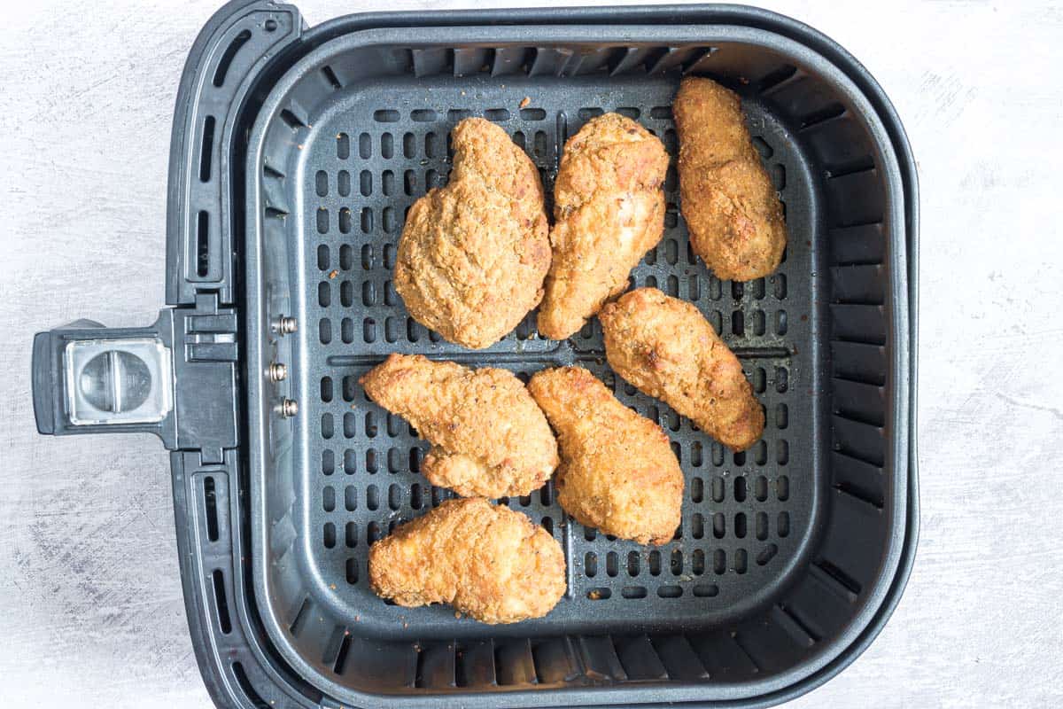top down view of reheat chicken wings in air fryer basket