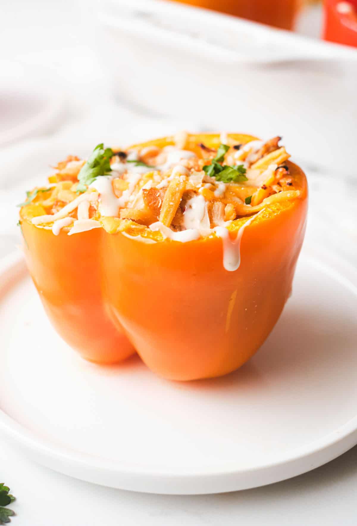 close up of one of the buffalo chicken air fryer stuffed peppers served on a white plate
