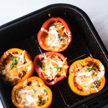 top down view of the air fryer stuffed peppers inside the air fryer basket