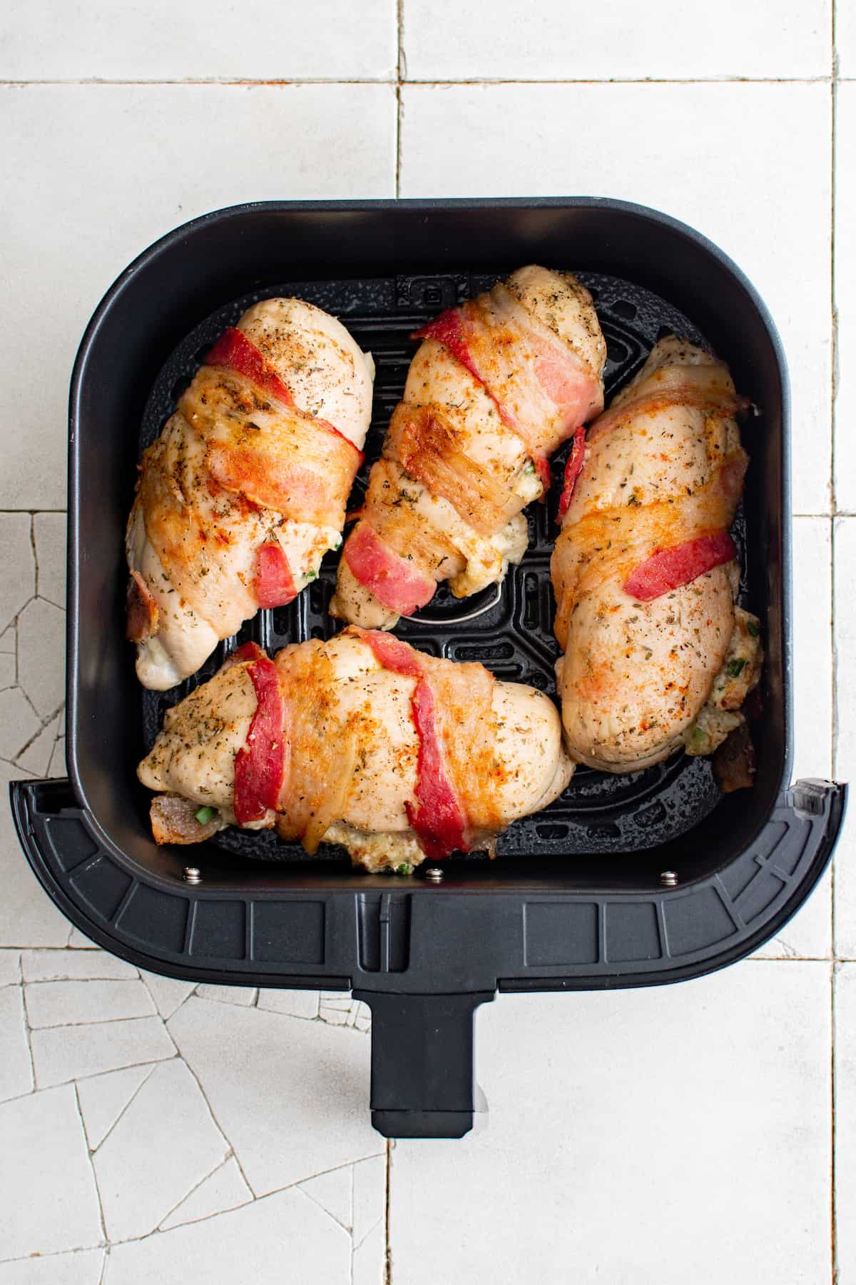 top down view of the finished air fryer stuffed chicken breast inside the air fryer basket