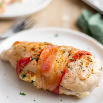 one finished air fryer stuffed chicken breast served on a white plate