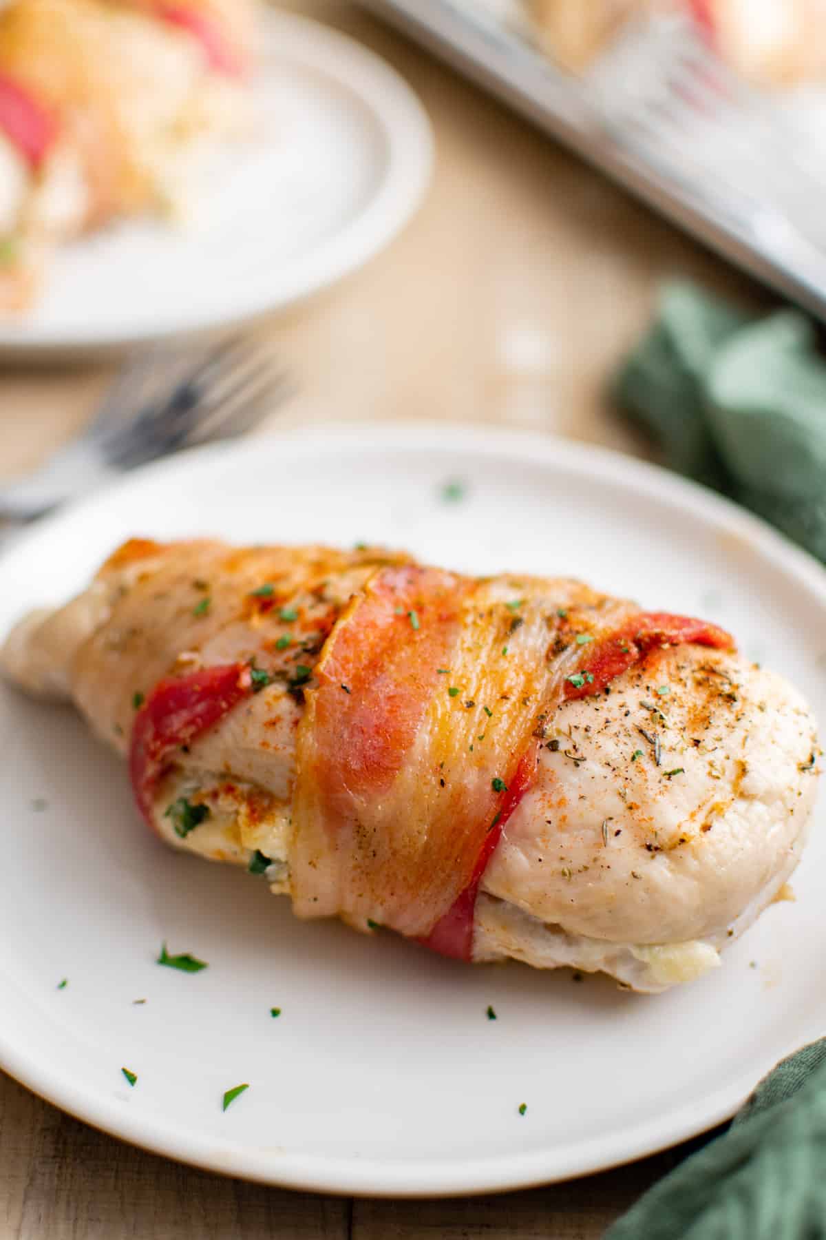 one finished air fryer stuffed chicken breast served on a white plate