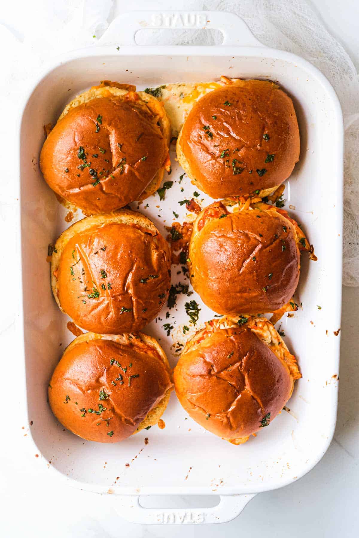 top down view of the buffalo chicken sliders inside the baking dish