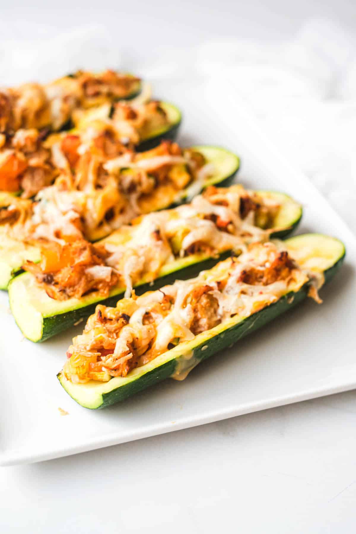 side view of the finished air fryer buffalo chicken zucchini boats