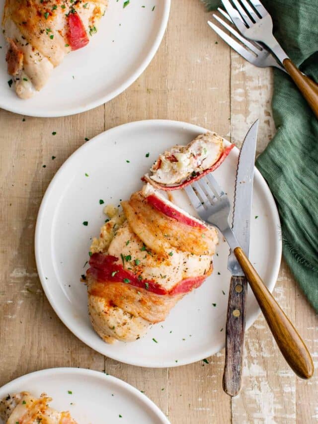 top down view of the finished air fryer stuffed chicken breast served with a knife and fork