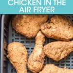 fried chicken pieces in an air fryer basket