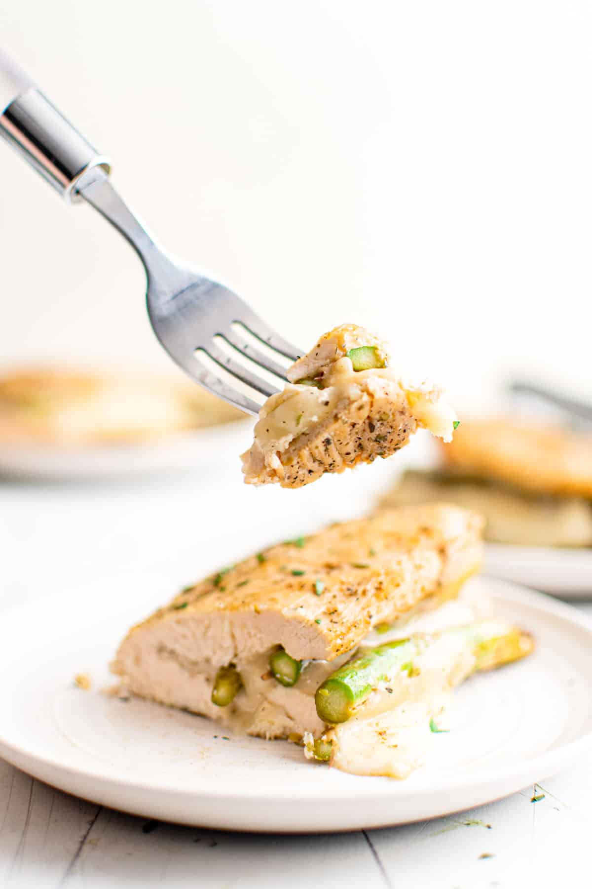 one serving of instant pot stuffed chicken breast with a fork removing a bite