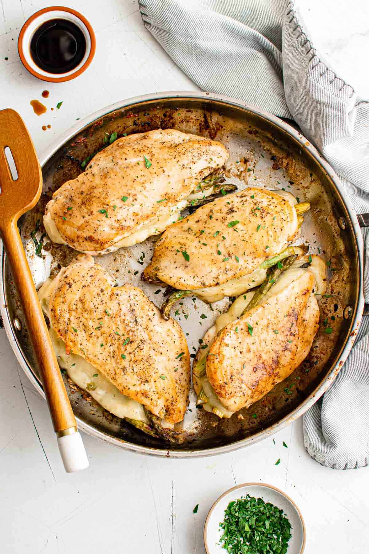 top down view of asparagus stuffed chicken breast inside a skillet