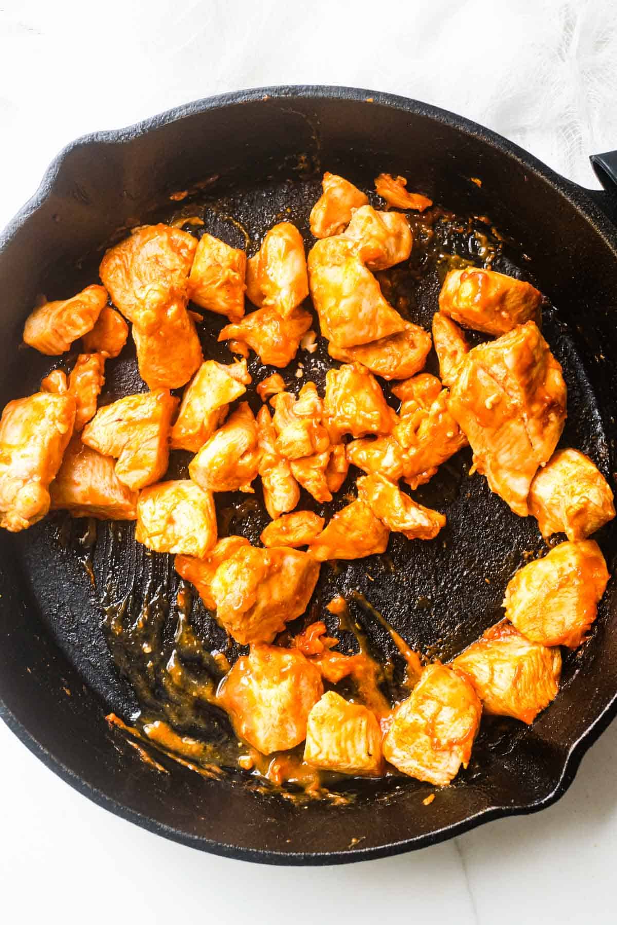 top down view of the buffalo chicken bites in a skillet