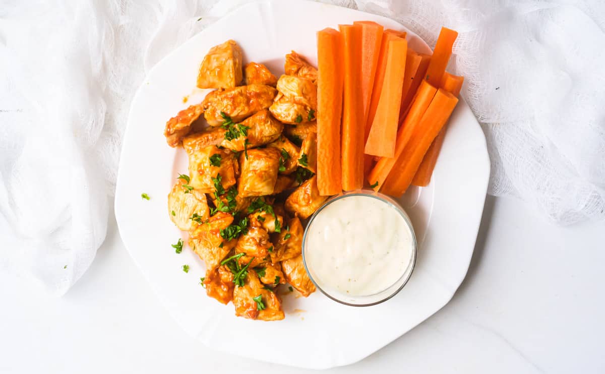 buffalo chicken bites served with carrot sticks and a side of ranch dressing