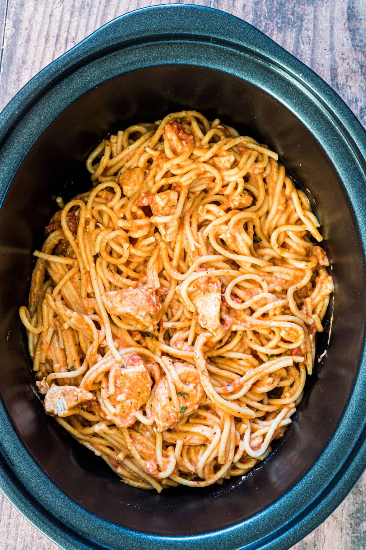 A crockpot full of slow cooker chicken spaghetti