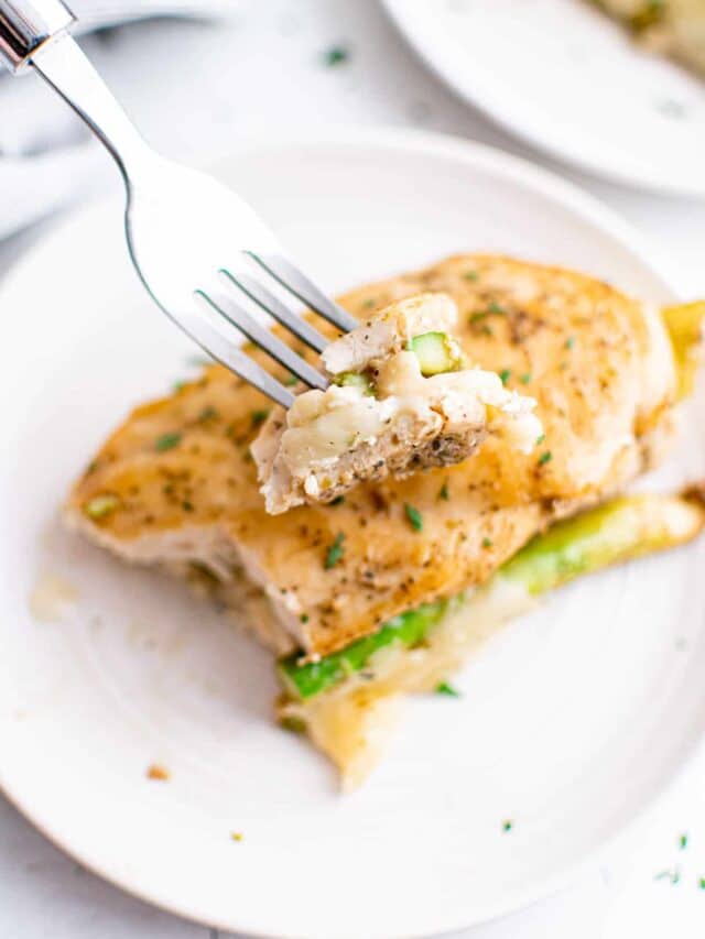a fork removing one bite of the completed instant pot stuffed chicken breast