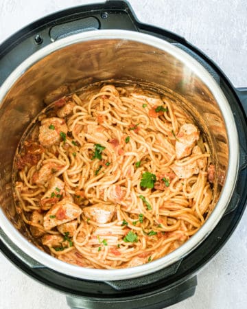 Instant Pot Chicken Spaghetti in an instant pot with herb garnish
