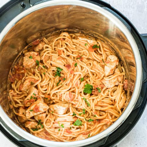 Instant Pot Chicken Spaghetti in an instant pot with herb garnish