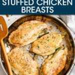 four stuffed chicken breasts in a pan with a wooded spatula