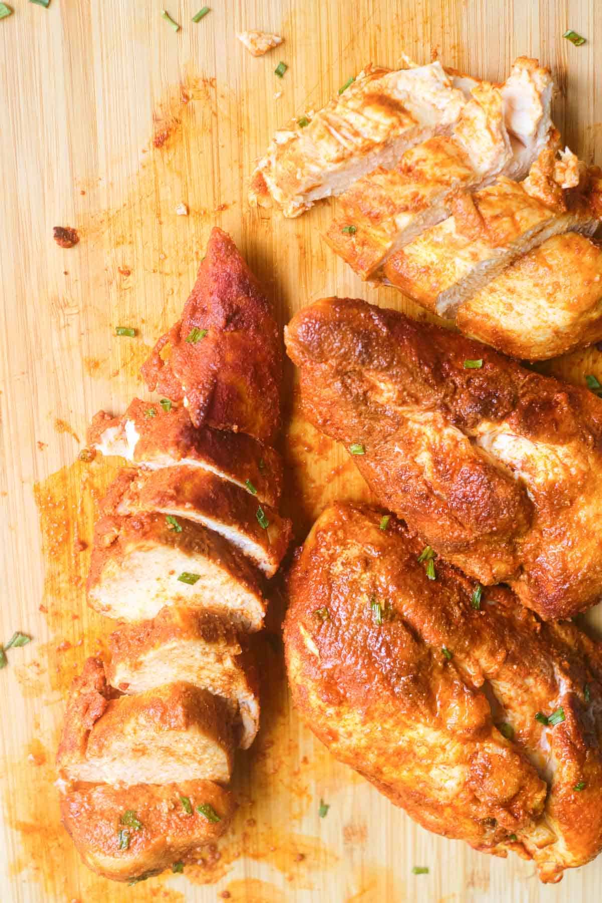 top down view of sliced instant pot chicken breast on a curing board