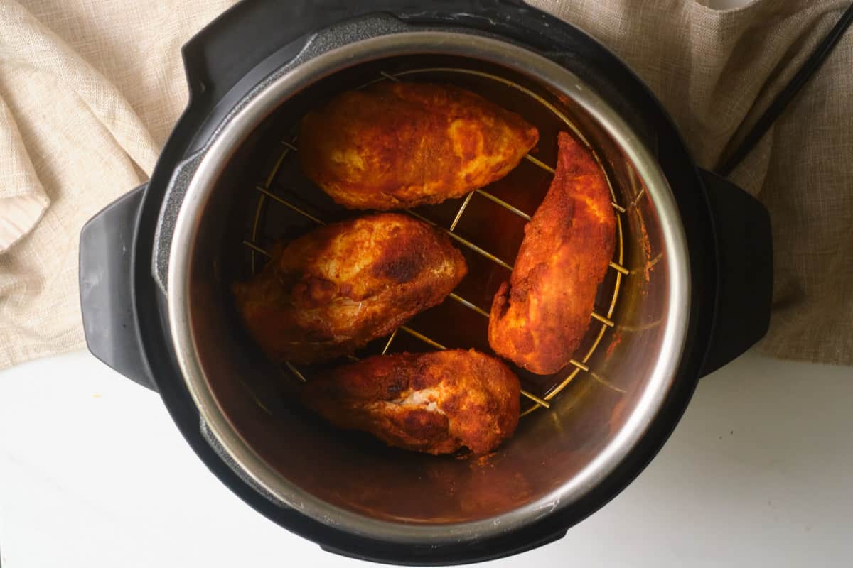 the completed instant pot chicken breast inside the instant pot