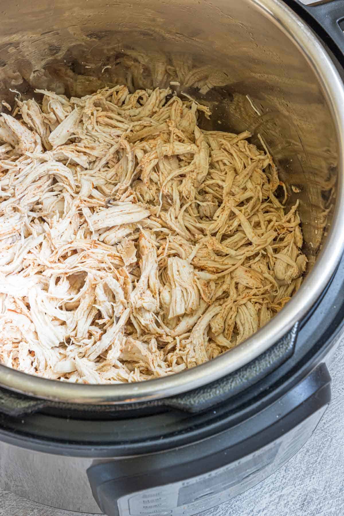 the finished instant pot shredded chicken inside the instant pot