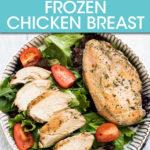 TWO CHICKEN BREASTS, ONE SLICED, IN A BOWL WITH SALAD