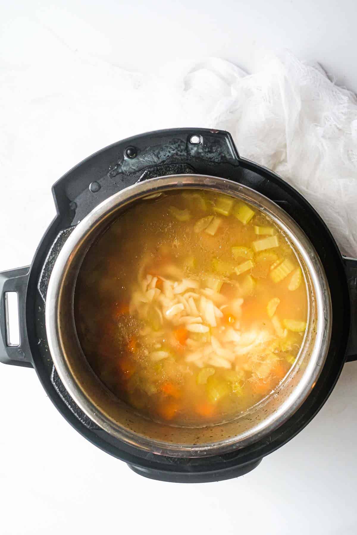 top down view of the finished instant pot lemon chicken orzo soup inside the instant pot