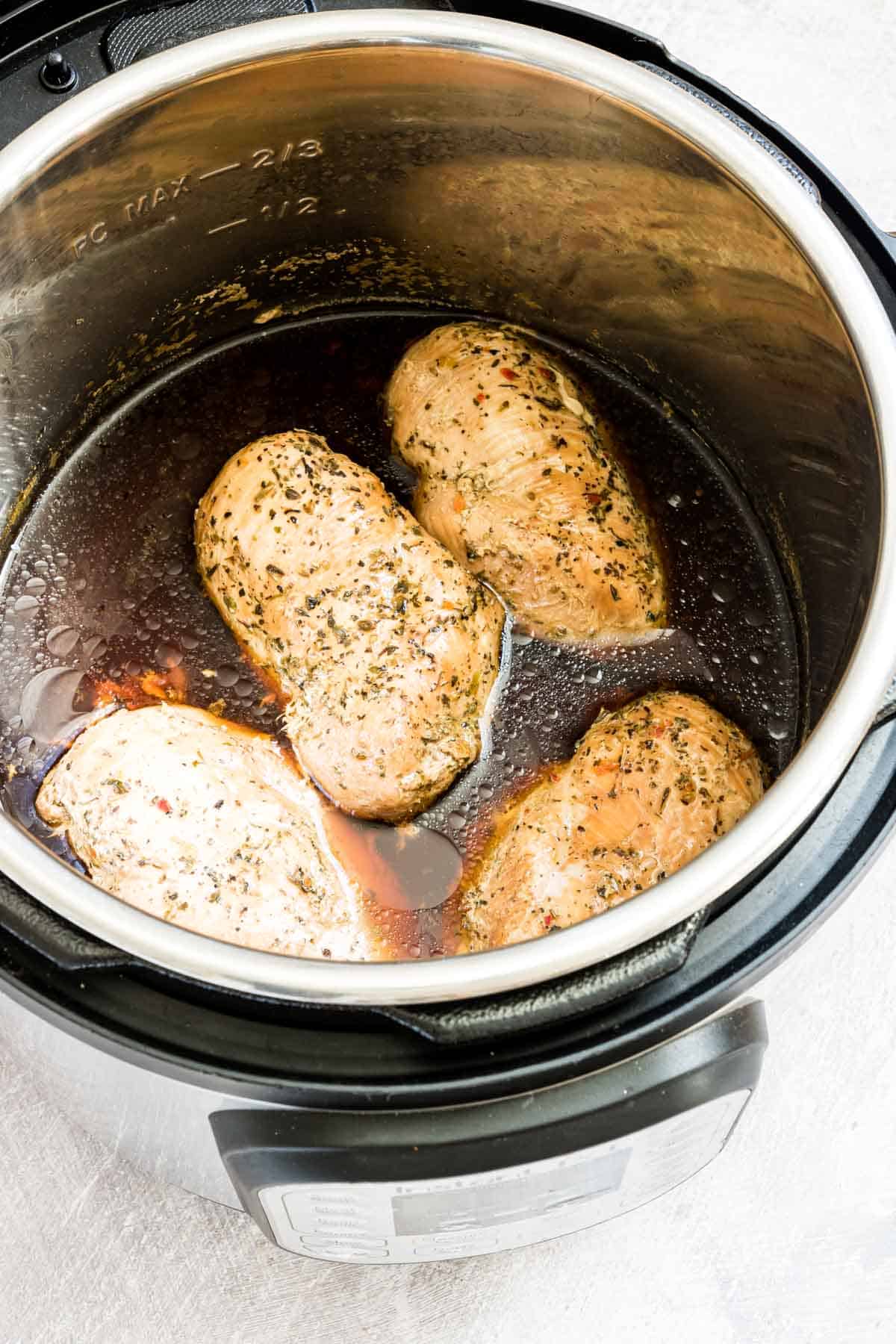 the completed instant pot frozen chicken breast inside the instant pot insert.