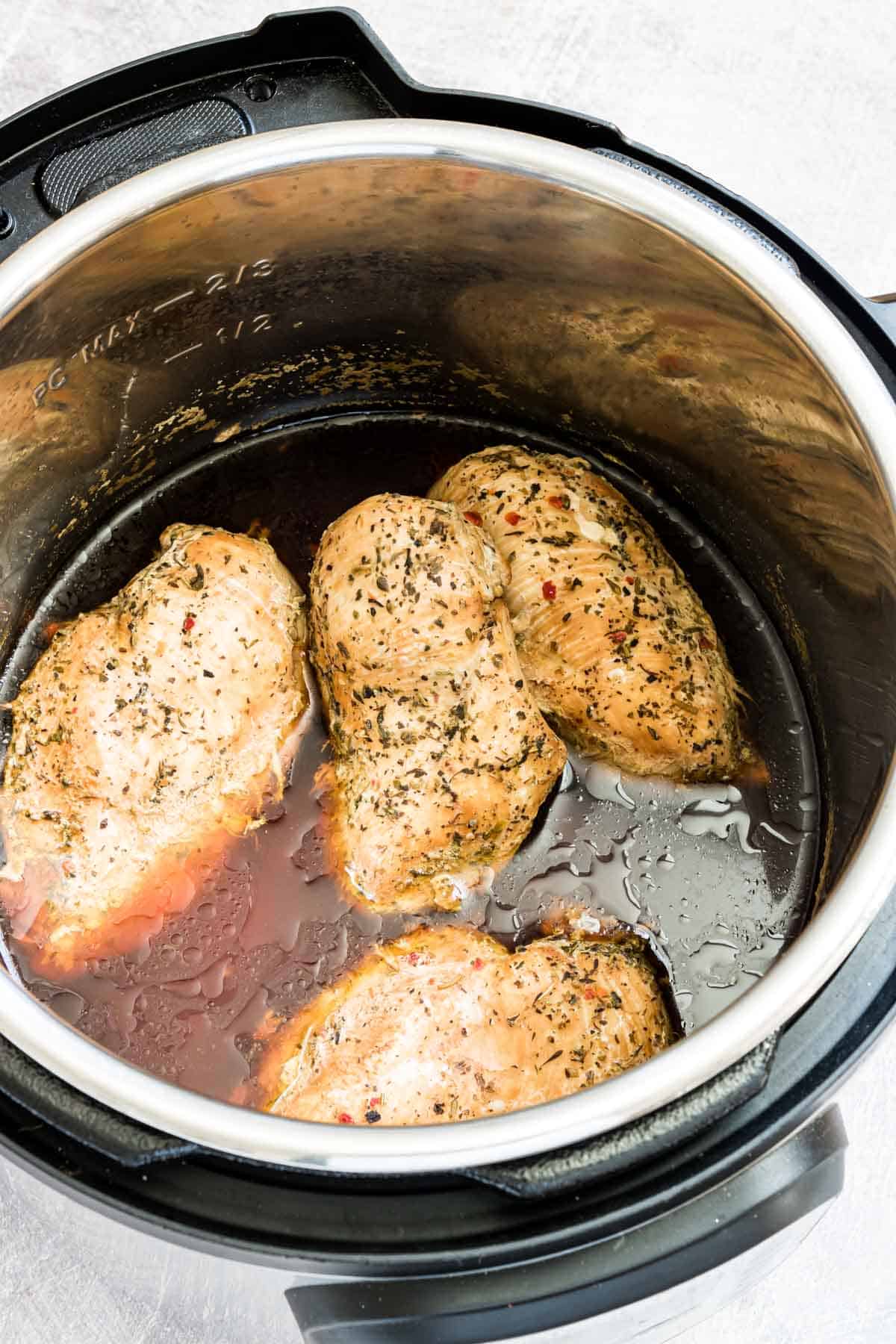 top down view of the instant pot frozen chicken breast inside the instant pot.