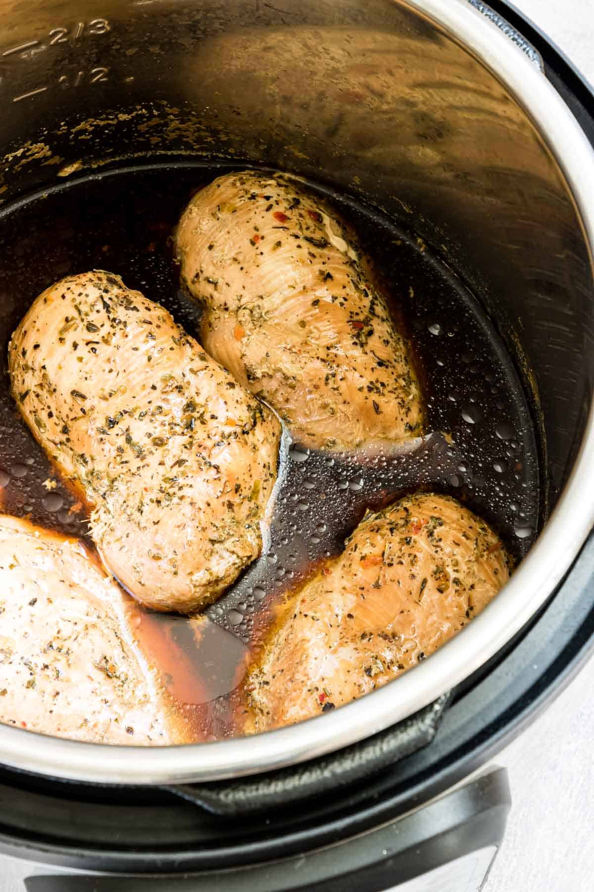 close up view of frozen chicken breast in instant pot