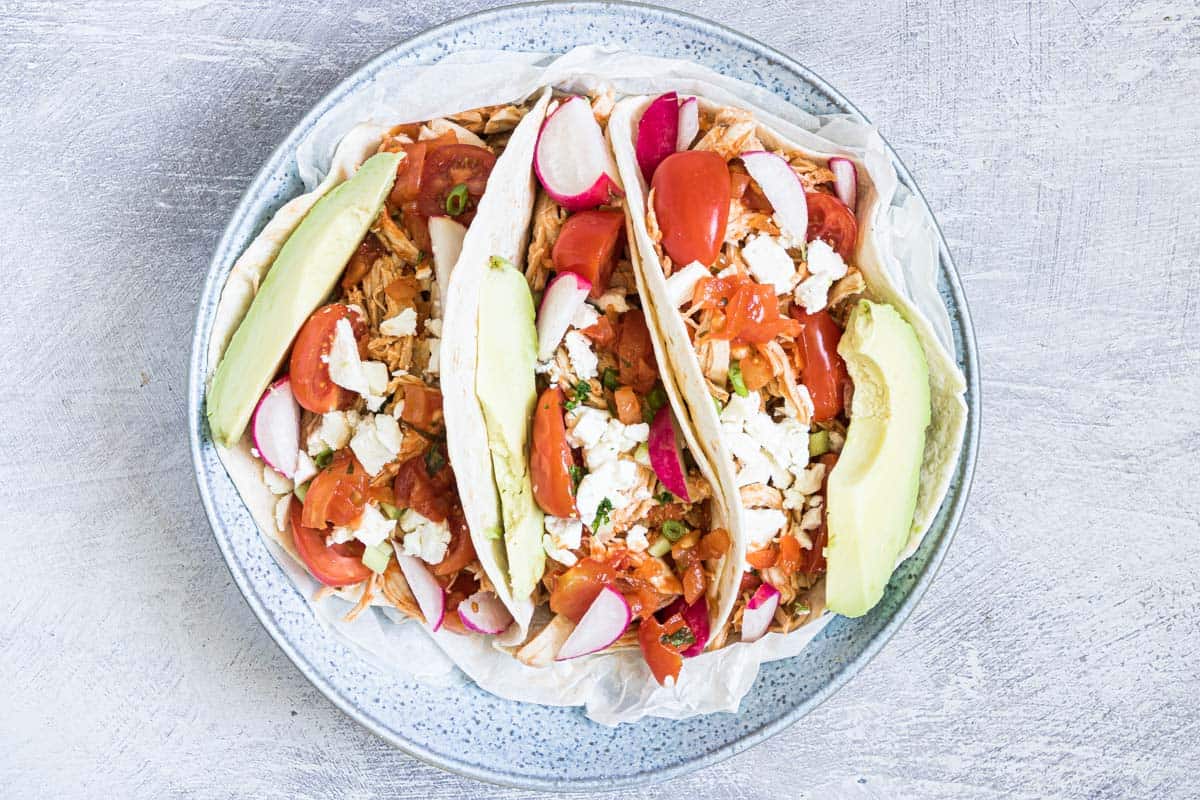 top down view of three instant pot shredded chicken tacos.