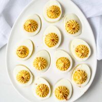 a plate of mexican deviled eggs on a ttable