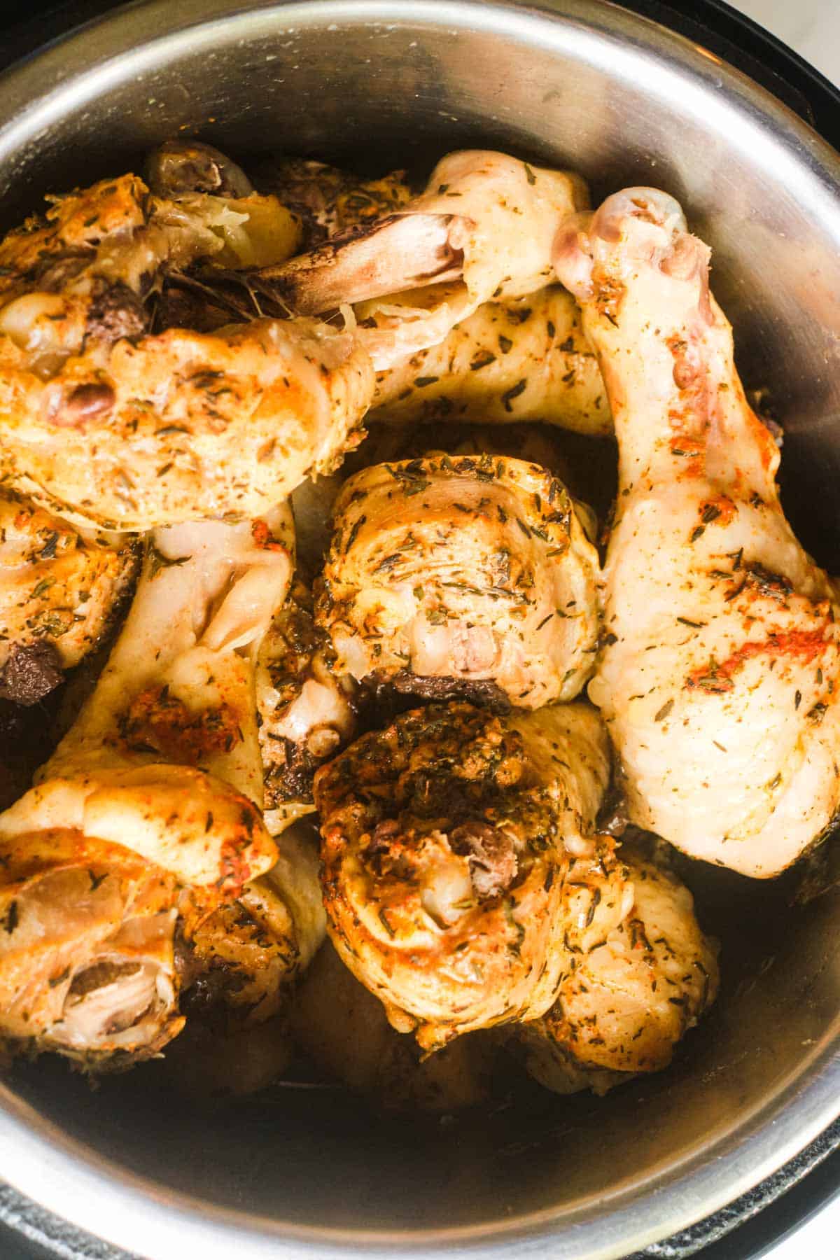 close up view of the instant pot chicken drumsticks inside the instant pot insert