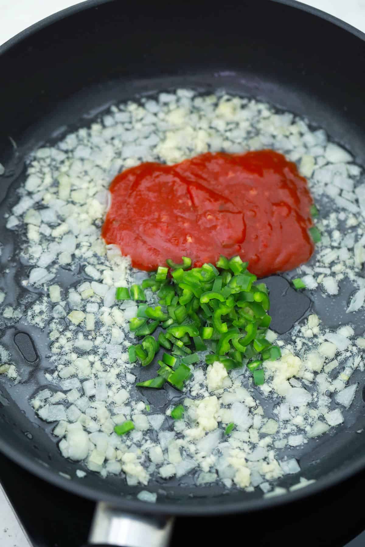 peppers, onions and salsa for making chicken taquitos being cooked in a saucepan