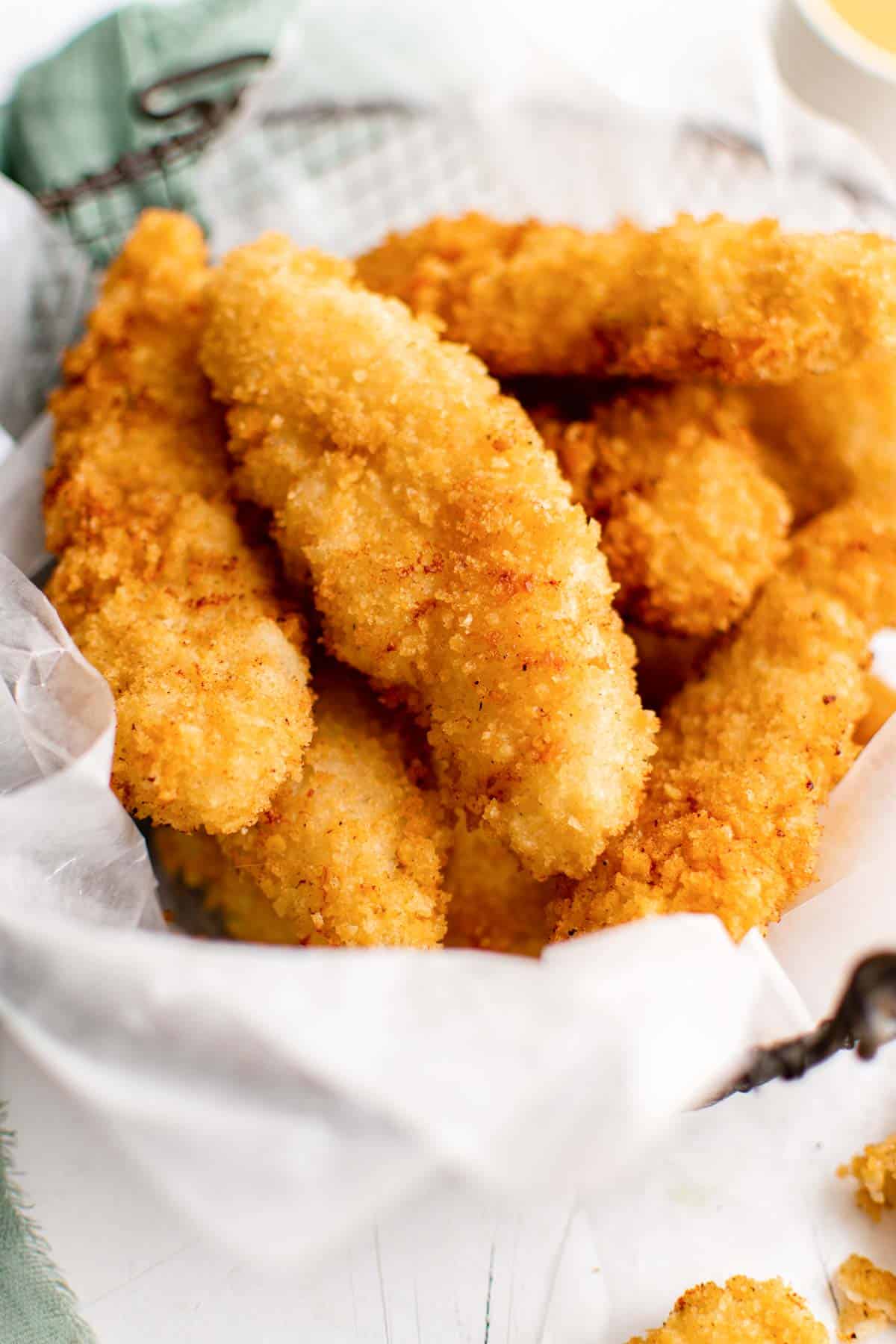 a batch of buttermilk chicken tenders piled into a basket