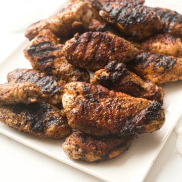 the completed grilled chicken wings recipe served on a white platter
