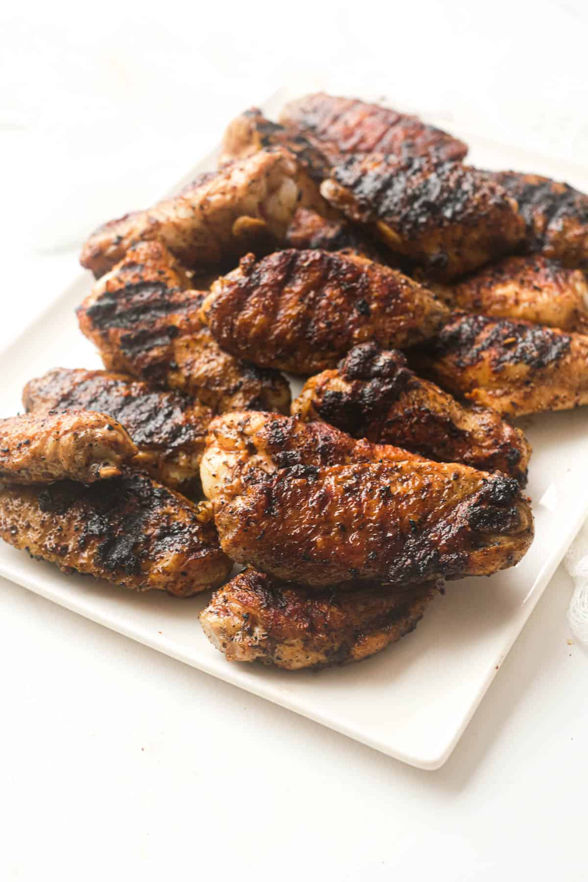 the completed grilled chicken wings recipe served on a white platter