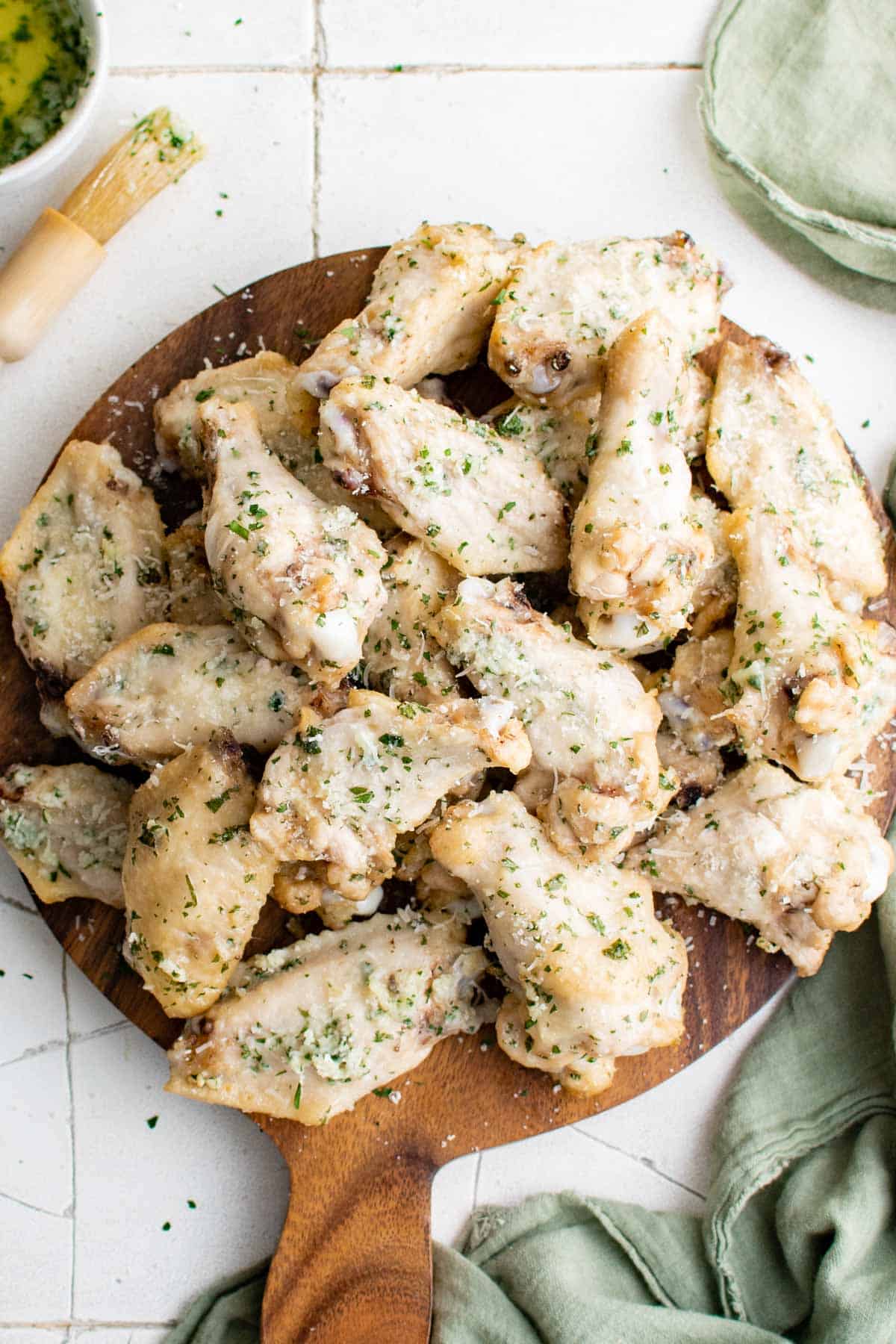 top down view of the garlic parmesan wings on a wooden serving board