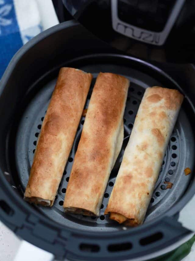 3 air fryer chicken taquitos in an air fryer basket