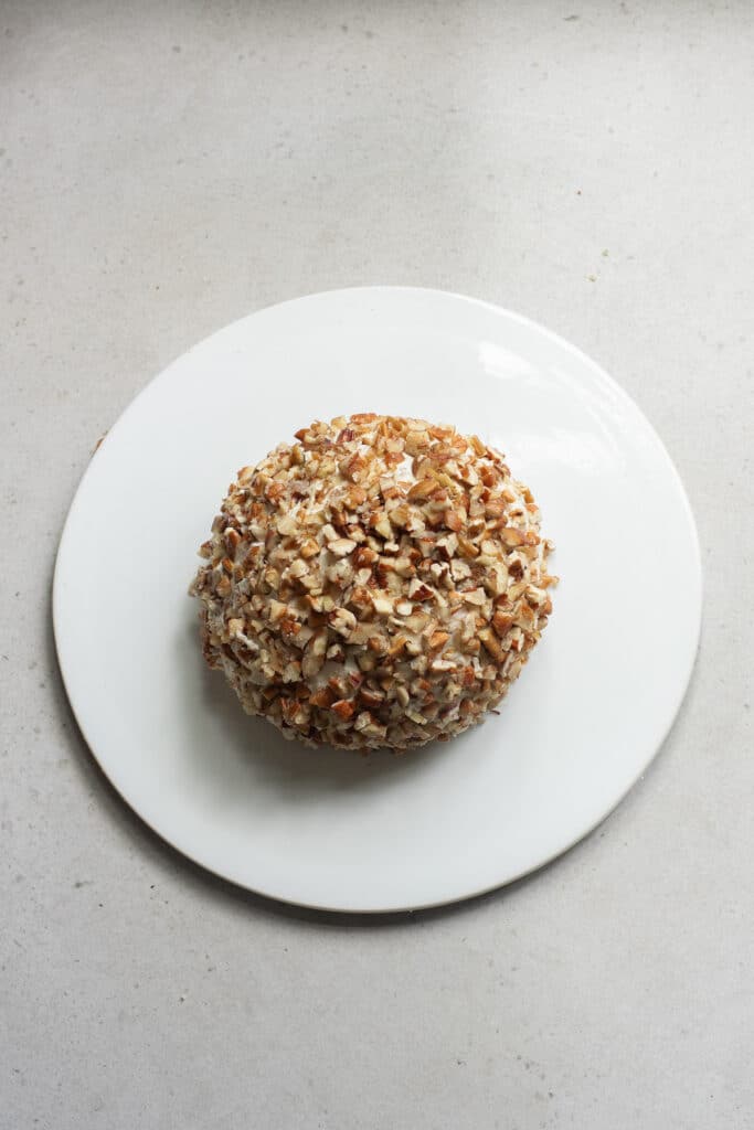 the completed pecan coated cheese ball on a platter.