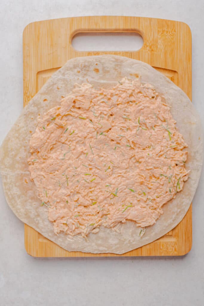 the chicken and cheese mixture spread onto a tortilla